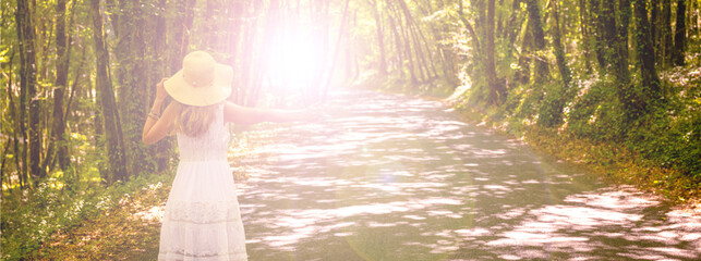 woman alone with dress and hat in forest