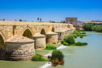 Fototapeta na wymiar Cordoba, Spain. Roman Bridge on Guadalquivir river and The Great Mosque (Mezquita Cathedral) in the city of Cordoba, Andalusia.
