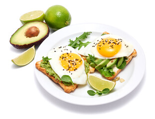 sliced avocado and fried egg on toasted bread isolated on white background