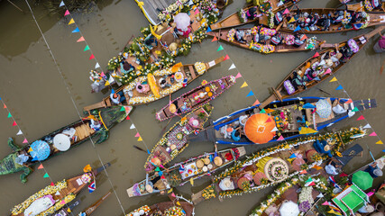 Aerial view floating festival in Thailand, People enjoy the candle procession in the river...