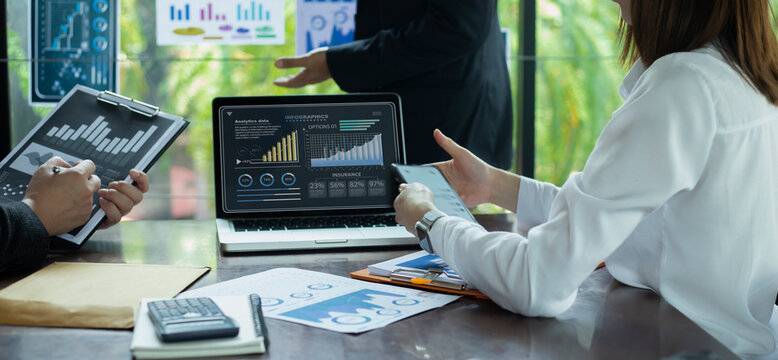 Technology and financial advisory services concert. Business teamwork and working on digital laptop computer with advisor showing plan of investment to clients at table office. Digital marketing.
