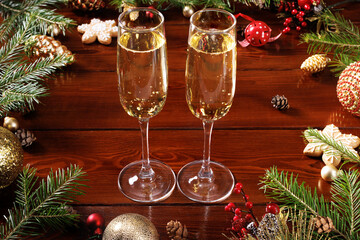 Celebration of Christmas and New Year with champagne. Two glasses of champagne on a New Year's decorated table.