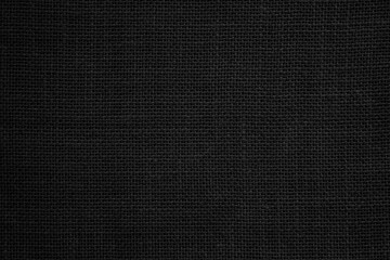 Black hemp rope texture background. Haircloth wale black dark cloth wallpaper. Rustic sackcloth canvas fabric texture in natural.

