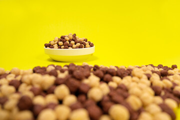 Corn balls with cocoa on a yellow background. Quick cereal healthy breakfasts for children and adults.