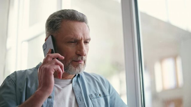 Senior man talking on the phone with his friend, sharing thoughts, communication - Powered by Adobe