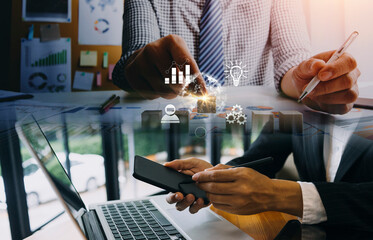 Businessman and team analyzing financial statement Finance task. with smart phone and laptop and tablet. Wealth management concept