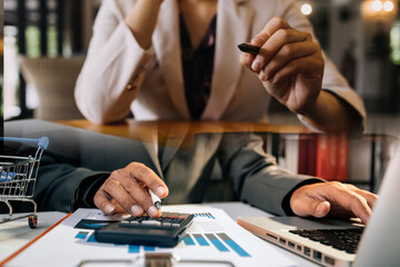 Businessman and team analyzing financial statement Finance task. with smart phone and laptop and...