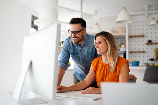 Portrait of success business people working together in home office. Couple teamwork startup concept