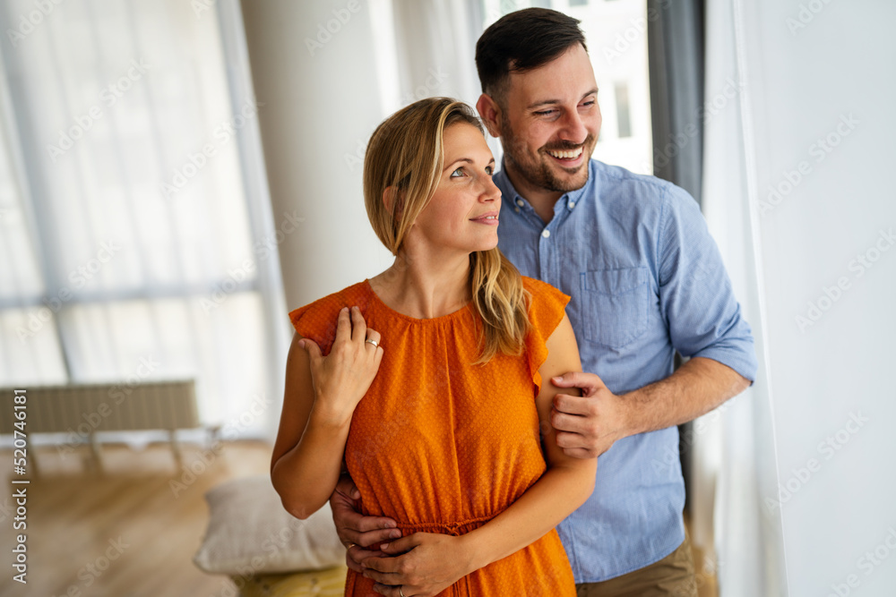 Wall mural Portrait of loving couple hugging each other and spending romantic time together.