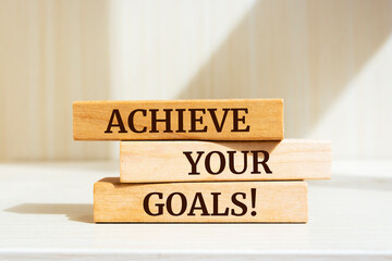 Wooden blocks with words 'Achieve Your Goals'.