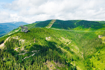Aerial view of the worlds longest 721 meter suspension footbridge Sky bridge and observation tower the Sky walk in the forest, between mountains, Dolni Morava Ski Resort, Czech Republic.  - obrazy, fototapety, plakaty