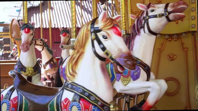 Old French carousel in park. Horses on traditional vintage carousel. Merry-go-round with horses