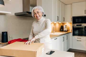 Senior woman unpacking a delivery at home