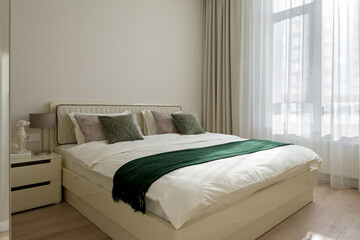 interior of a bedroom, modern bedroom in beige tones

