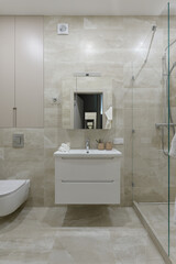 modern bathroom interior, bathroom with beige tile with stone texture

