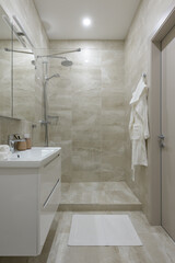 modern bathroom interior, bathroom with beige tile with stone texture
