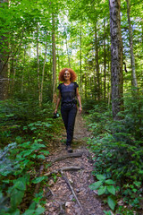 Lady nature photographer hiking on a trail