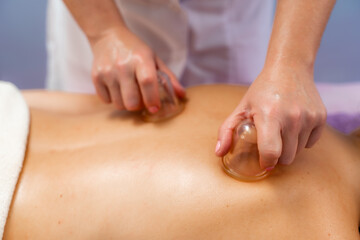 Obraz na płótnie Canvas Facial massage. A woman is given a massage in a beauty salon. Close-up.