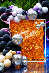 Photo zone and decor for birthday party in disco style.