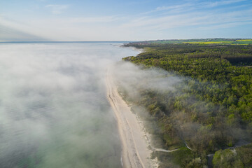 fog over the ocean hitting the shore in denmark