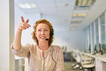 Customer advisor with headset in the service hotline