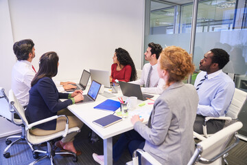 Business people in business meeting look at wall