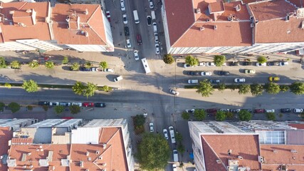 Aerial view of the city roads and vehicles between buildings