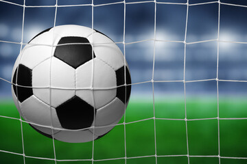 Soccer ball in goal on stadium