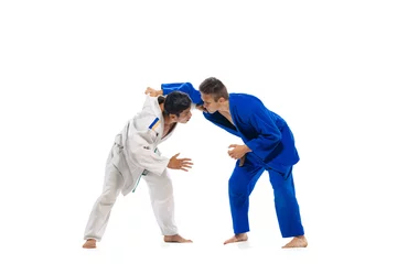 Fotobehang Studio shot of two men, professional judo, combat sport athletes training isolated over white background © Lustre