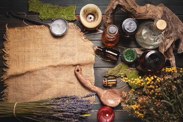 Herbal medicine concept background. Dry natural ingredients and remedy bottle on the wooden table...