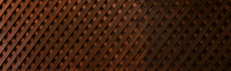 Textures of abstract brown wooden background. An old wooden wall. The boards are nailed diagonally. View from above. Banner.