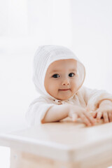 cute studio portrait of a little newborn girl posing for a photo on a light background