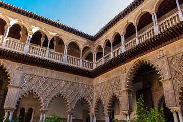 Obraz premium Seville, Spain, September 12, 2021: The Royal Palace of Seville (Real Alcazar). The Maidens Courtyard. The Mudejar of Pedro I on the ground floor and the Renaissance of the first monarchs.