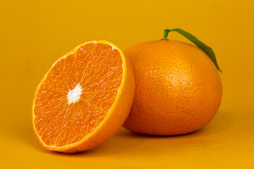 Juicy Orange fruit with leaf isolated. and Orang whole, slice, leaves on white. Orange slice with isolated on yellow background