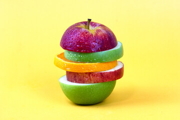 Sliced apple with piece of lemon isolated on yellow background. New isolate style for Fruit concept design