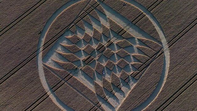 Top down aerial view descending towards Micheldever Station mysterious geometric crop circle shapes on agriculture field