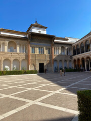 Fototapeta na wymiar Sevilla, Spain, September 11, 2021: The Royal Palace of Seville (Real Alcazar). Mudejar Palace of Pedro I in the Hunting Courtyard (Patio de la Monteria).
