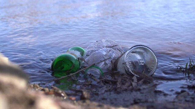 Plastic bottle and glass bottles in the lake.
Image of glass bottles and plastic waste in the lake. Environment and water pollution. Timelapse video.
