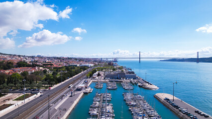 Obraz premium Lisbon, Portugal, April 24, 2022: Aerial view of the Doca de Belem (Sailing boat dock) along Tagus river in Belem district, Lisbon, Portugal.