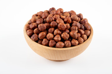 Bowl full of hazelnuts  on white background