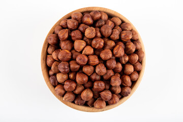 Bowl full of hazelnuts  on white background