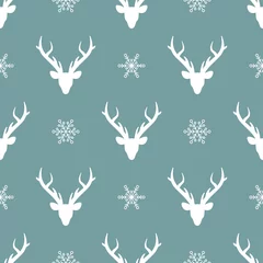 Fototapeten seamless winter pattern with white snowflakes and deer heads with antlers. © Ne Mariya