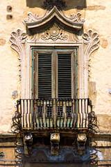 City of Messina, Sicily, Italy. Wrought iron balustrade. Typical Baroque style old window balcony