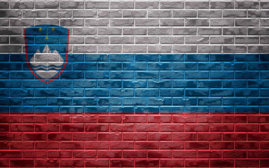 Country national flag on a brick wall, background and texture.Slovenia flag.