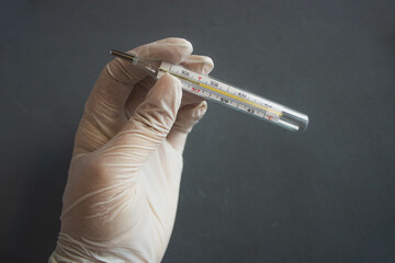 mercury thermometer on a gray background