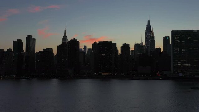 low altitude aerial trucking shot southbound of the legendary Manhattan skyline at dusk