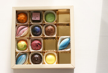 Chocolate candirs on white background. Flat lay, top view composition with copy space. Flatlay mockup made of multi-colored candy.
