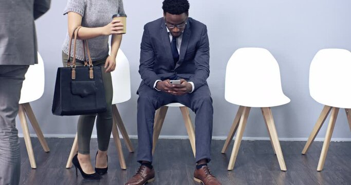 Diverse group of business people applying for a job at an agency. Professional candidates sitting in a row, waiting for an interview. Ambitious workers in line for a vacant position at a company