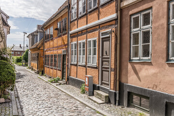 cobbled lane with traditional picturesque wattle houses, Helsingor, Denmark