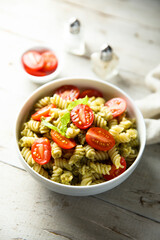 Pasta with pesto sauce and cherry tomatoes